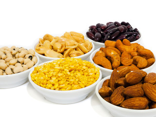 Almond, Cashew nuts, yellow bean, green bean, rice, fettucine, all put on small white cup and on white background