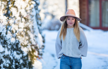 Cute lady with a hat outside. Cold winter time.