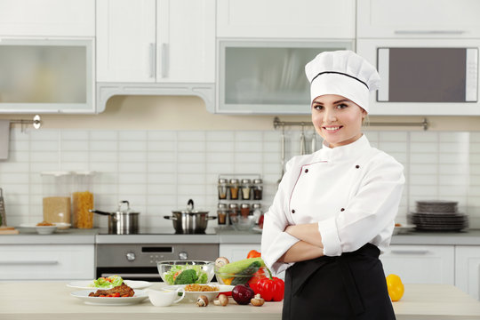 Young woman chef in modern kitchen