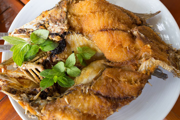 Deep fried snapper topped with sweet fish sauce with herbs