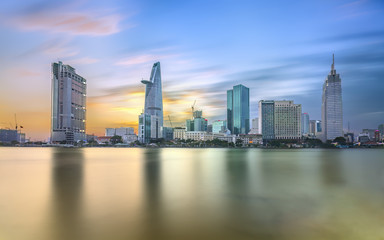 Fototapeta na wymiar Ho Chi Minh City, Vietnam - February 14th, 2017: Beauty skyscrapers along river light smooth down urban development in Ho Chi Minh City, Vietnam