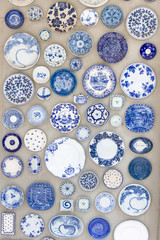 Porcelain plates placed on the cement floor for background.