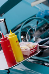 Drive-in Food on a Window Tray of a Retro Car