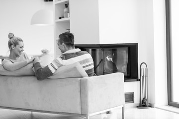 Young couple  in front of fireplace