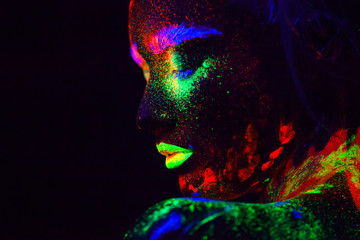 Beautiful extraterrestrial model woman with blue heair and green lips in neon light. It is portrait...