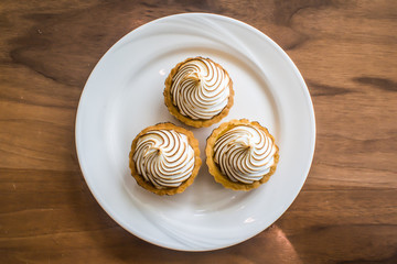 Mini Lemon Meringue on a plate, ready to eat.