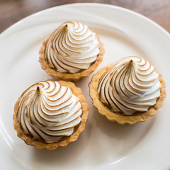 Mini Lemon Meringue on a plate, ready to eat.