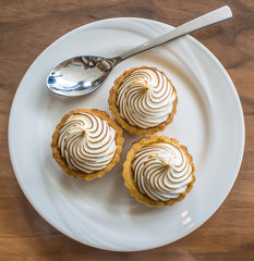 Mini Lemon Meringue on a plate, ready to eat.