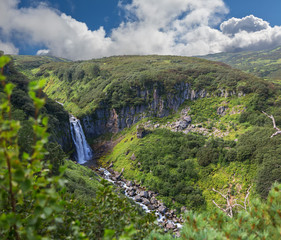 Fototapeta na wymiar Waterfall Spokoyny in brookvalley at the foot of outer north-eastern slope of caldera volcano Gorely.