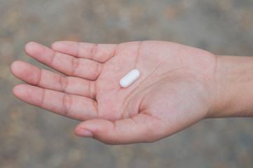 Medicine pills or capsules in hand, Medicine in palm