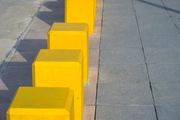 Yellow concrete walking street barriers