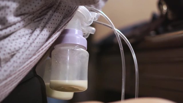 Mother pumped breast milk from her breast
