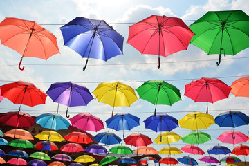 Fototapeta na wymiar Colorful umbrellas background. Coloruful umbrellas urban street decoration.