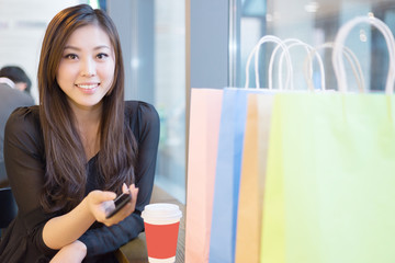 young asian woman shopping in modern shopping mall