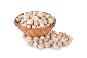 dried cardamom seed in bamboo basket and on white background