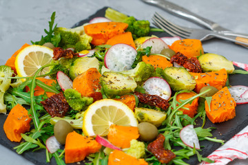 Steamed sweet potato, broccoli and other vegetables salad on slate. Love for a healthy vegan food concept