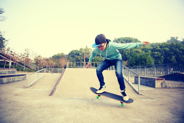 young skateboarder practice ollie at skatepark ramp © lzf