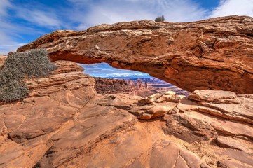 Fototapeta na wymiar Sandstone arch over the canyon. Mesa Arch. Canyonlands National Park. Moab. Utah. United States.