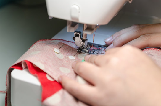 worker sewing with danger caution