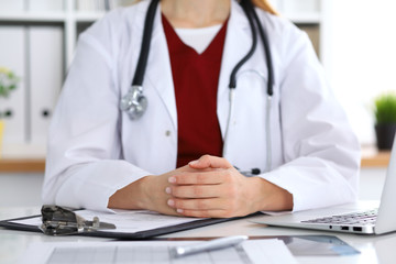 Close up of a unknown female doctor's hands. Physician is ready to consult and halp patients. Medicine and health care concept