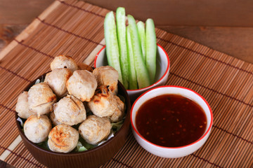 grilled meatball with spicy tamarind sauce  in bowl