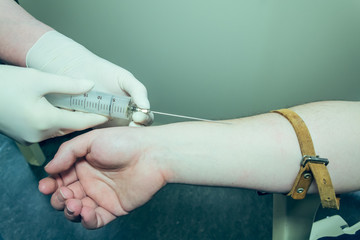 Doctor or nurse taking blood from a patient