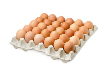 Brown eggs in the cardboard egg tray on light background