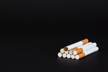 Cigarettes, tobacco, close-up on a black background.