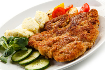 Fried pork chop, puree and vegetables 
