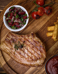Roasted pork steak on ribs.