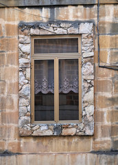 Fototapeta na wymiar Window in a stone frame. Malta