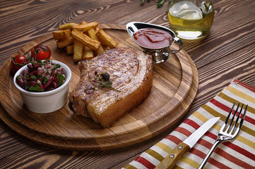 Roasted pork steak on ribs.