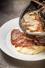 Chef pouring gravy sauce