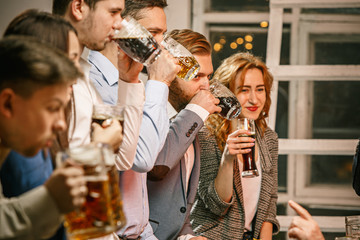 Group of friends enjoying evening drinks with beer