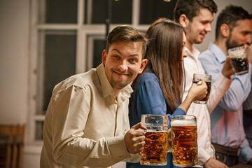 Group of friends enjoying evening drinks with beer