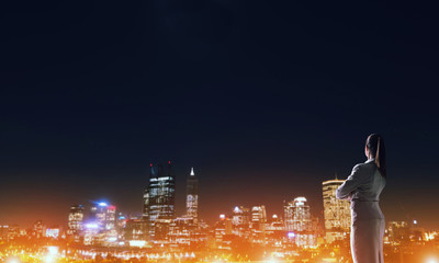 Woman looking at night city