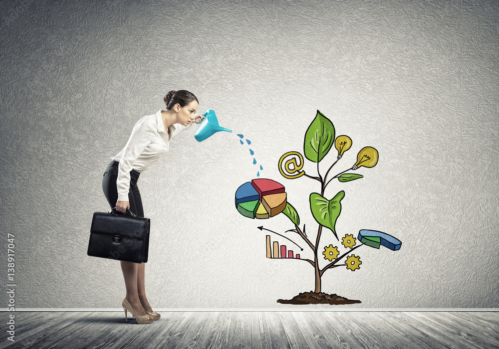 Wall mural young businesswoman in empty room watering drawn growth concept with can