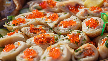Pancakes - a festive meal on Shrove Tuesday. Pancakes with red caviar. A traditional dish of Slavic cuisine. Selective focus