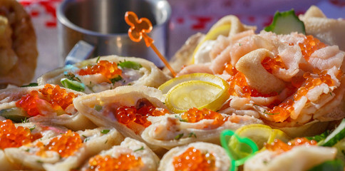 Pancakes - a festive meal on Shrove Tuesday. Pancakes with red caviar. A traditional dish of Slavic cuisine. Selective focus