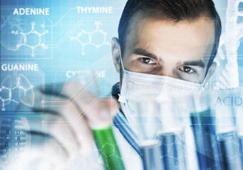 Portrait of concentrated male scientist working with reagents in laboratory