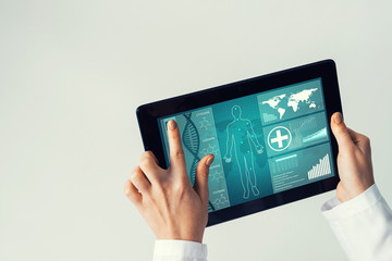 Close of female doctor hands working with tablet pc computer