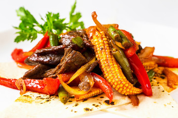 Plate of traditional mexican spicy salad with corn and chili pepper isolated at white background.