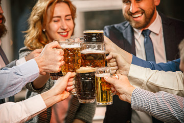 Group of friends enjoying evening drinks with beer
