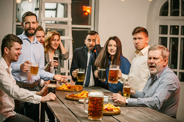 Group of friends enjoying evening drinks with beer
