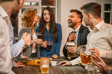 Group of friends enjoying evening drinks with beer