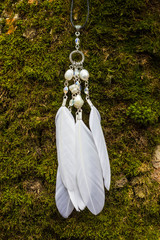 White pendant with feathers and beads handmade