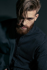 portrait of stylish handsome confident man on black