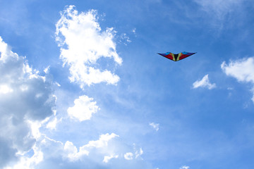Fototapeta na wymiar Kite on a blue sky background with clouds