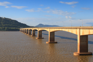 Fototapeta na wymiar Japanese bridge across the Mekong River in Laos