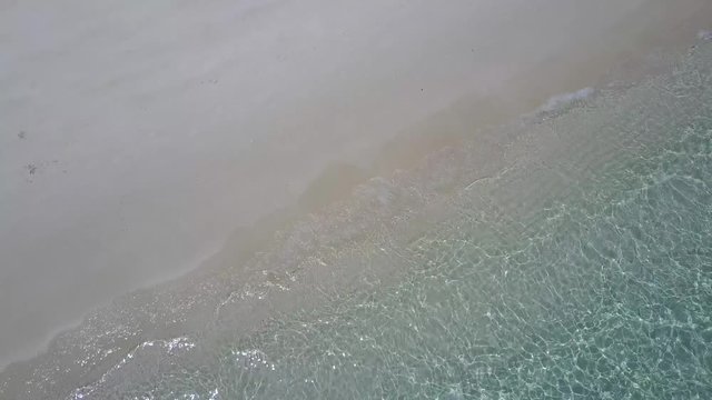 Gentle waves rolling onto Whitsunday beach